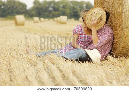 In Love Young Couple On Haystacks In Cowboy Hats
