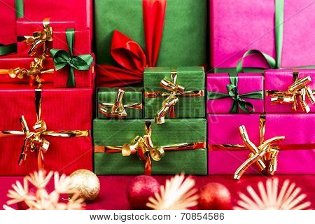 Three Stacks Of Xmas Presents Arranged By Color