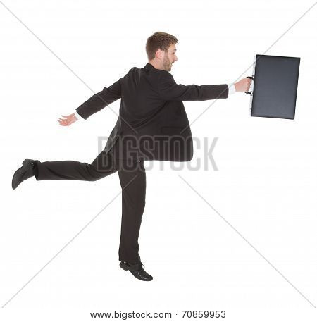 Businessman With Suitcase Running Over White Background