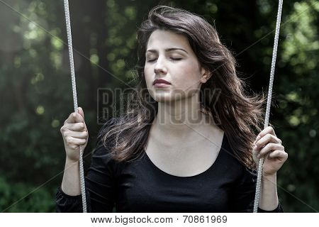Woman Swinging With Closed Eyes
