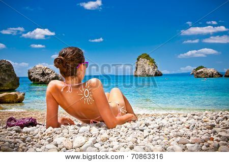 Beautiful woman on Piso Kryoneri beach in Parga, Greece.
