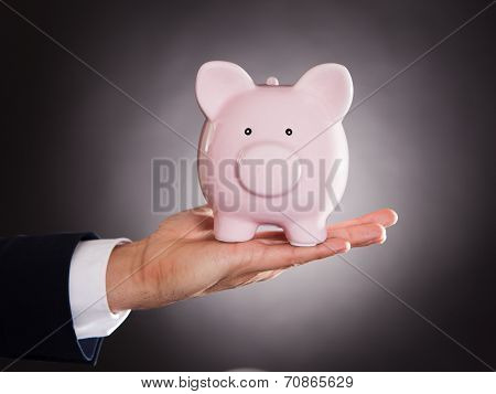Businessman Holding Piggybank