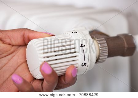 Woman Adjusting Thermostat
