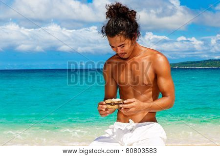 Happy Handsome Man Of Asian Appearance On The Tropical Beach