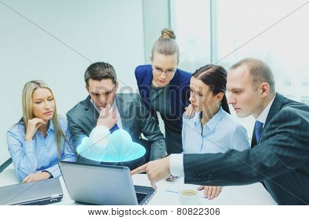 business, technology, people and cloud computing concept - serious business team with laptop computers and virtual projection having discussion in office