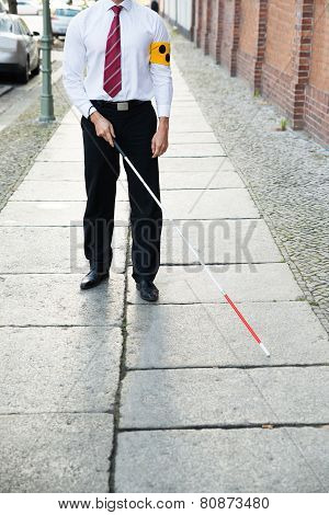 Blind Man Walking On Sidewalk