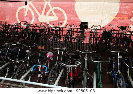 AMSTERDAM, NETHERLANDS - AUGUST 9, 2012: Colourful bicycles parked at the bicycle parking station next to the Central railway station in Amsterdam, Netherlands.