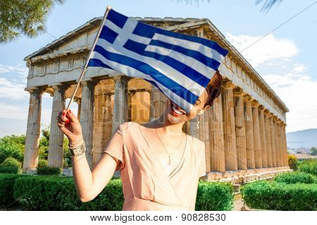 Woman with Greek flag on Hephaistos temple background