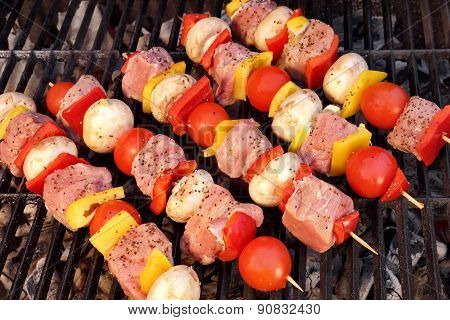 Pork And Vegetables Skewers Cooking On Bbq Grill