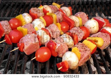Pork And Vegetables Skewers Cooking On Bbq Grill