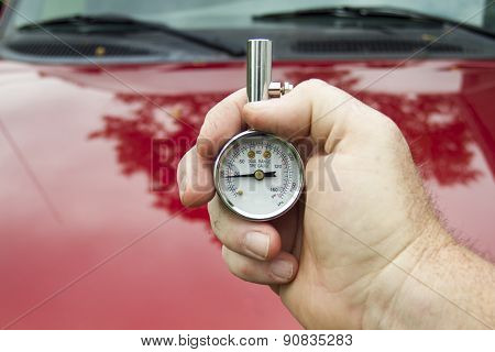 A Mechanic Measuring Psi Levels In A Tire
