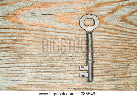 Old Key From The Lock On A Wooden Texture