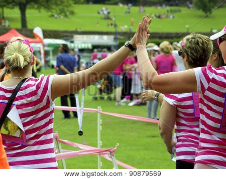 High five,s as they cross the finish line.