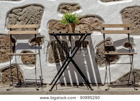 Empty table outside local cafe