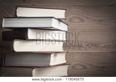 Old book on wooden background.