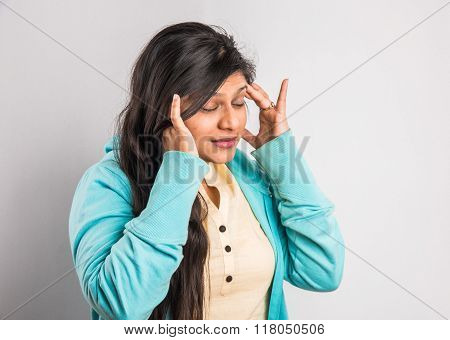 indian girl with headache, asian girl with headache, indian woman with headache holding her hand to