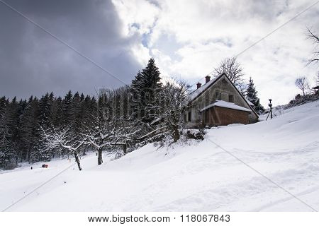 Snow Covered House In A Frosty Mountains Country In Sunny Winter Day