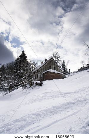 Snow Covered House In A Frosty Mountains Country In Sunny Winter Day
