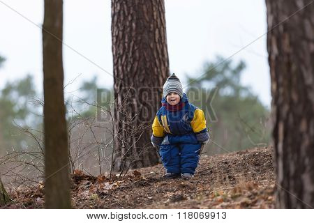 Little Caucasian Boy Playing In Forest At Early Spring