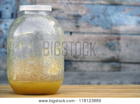 Bank with honey remains on table