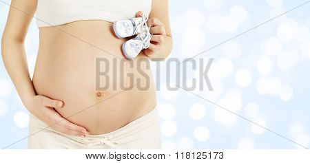 Pregnant Belly Holding New Born Baby Booties, Newborn Clothing