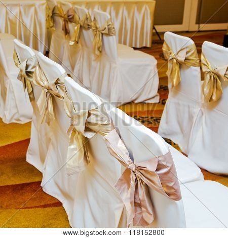 The back of yellow and gold wedding chairs