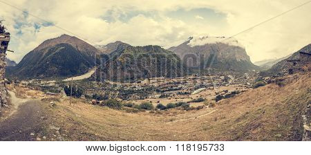 Mountain panorama with traditional stone build village.