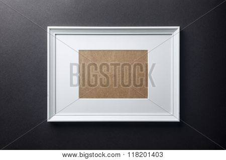 White wood frame on black wall
