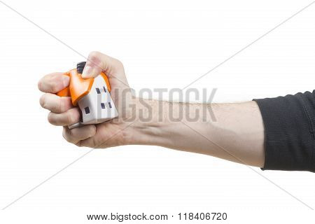 Male hand sqeezing a Stress ball house