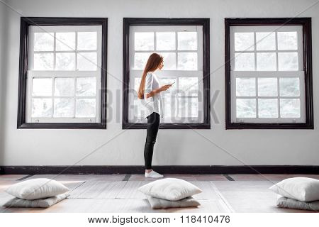 Woman using phone in the gym