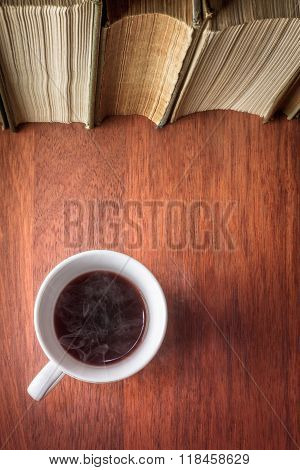 Cup Of Coffee With Stack Of Old Books