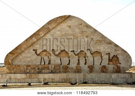 Sign at entry to Lokbatan, with camels