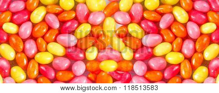 Background of colored candies in the form of eggs
