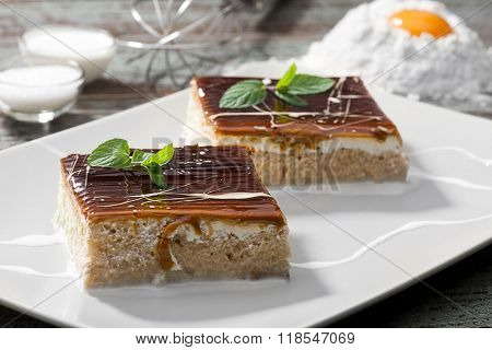 Traditional Turkish three milk cake with caramel on plate. 