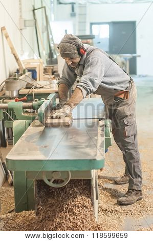 Carpenter using belt sander