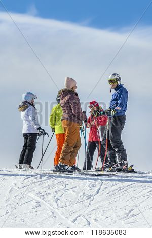 Skiers Resting On The Sky Slope