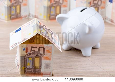 Bank note house with piggy bank