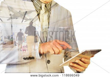 Double Exposure Image Of Businessman Use Digital Tablet And People Walking In Airport Terminal