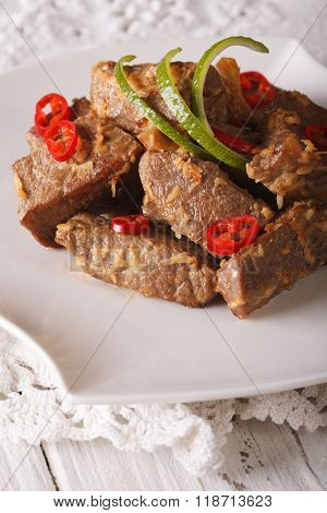 Rendang Beef Stewed In Coconut Milk With Spices Close-up On A Plate