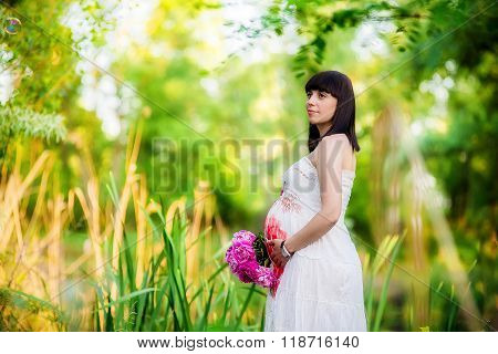 Pregnant Woman Near The Lake.
