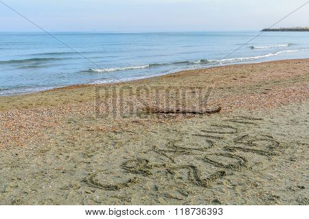Seashore, Sand And Water With Christmas Message Written. Sea Water And Sand With Shells With 