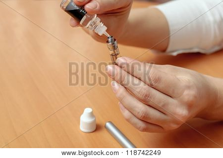 Female Hands Closeup Fill With Liquid In The E-cigarette