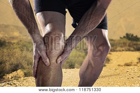 Young Sport Man With Athletic Legs Holding Knee In Pain Suffering Muscle Injury Running