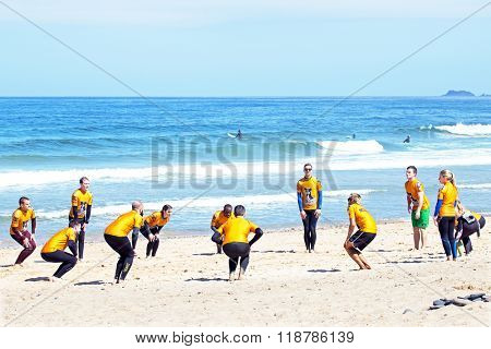 VALE FIGUEIRAS, PORTUGAL - August 20 2014: Surfers doing excersises on the famous surfers beach Vale Figueiras in Portugal
