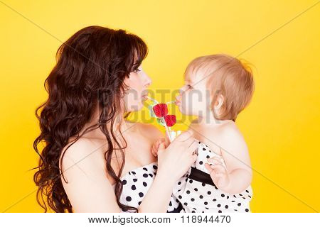 Mummy with the child drink tasty juice. Their complete harmony and understanding.