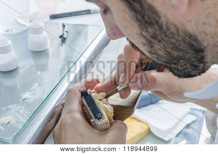 Dental Technician Applying Ceramics To Teeth In The Dental Model.
