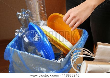 Woman sorting different waste, indoors