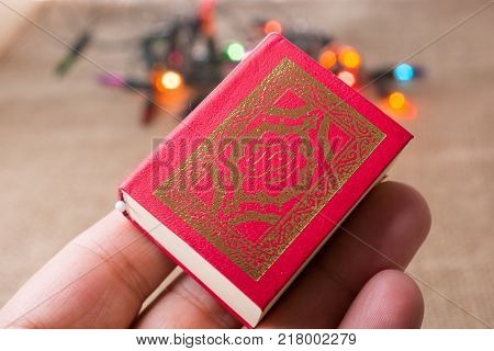 Islamic Holy Book Quran with lights behind