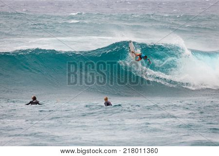 SUNSET BEACH HAWAII USA - DECEMBER 2, 2017: Surfer competing at the 2017 Vans World Cup of Surfing competition at Sunset Beach on Oahu's scenic North Shore. This is the second of three surfing competitions and Conner Coffin took first place.