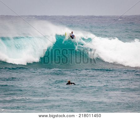 SUNSET BEACH HAWAII USA - DECEMBER 2, 2017: Surfer competing at the 2017 Vans World Cup of Surfing competition at Sunset Beach on Oahu's scenic North Shore. This is the second of three surfing competitions and Conner Coffin took first place.